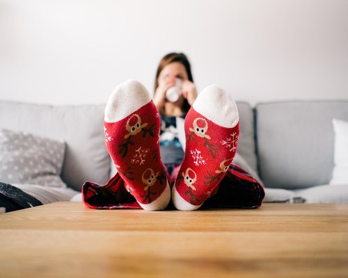 Person resting in a cozy Mexican living room with soft natural light