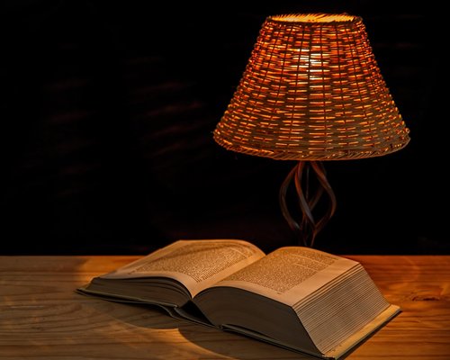 Soft bedside lamp lighting a room for reading